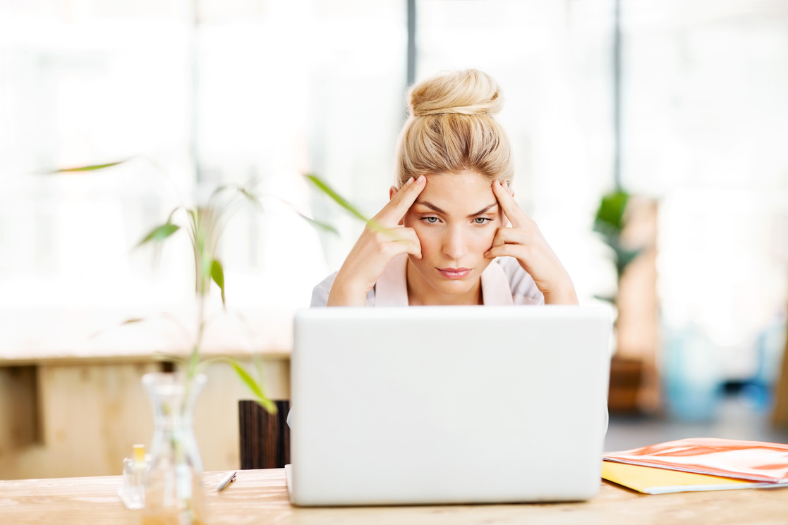 Worried Female Entrepreneur Looking At Laptop