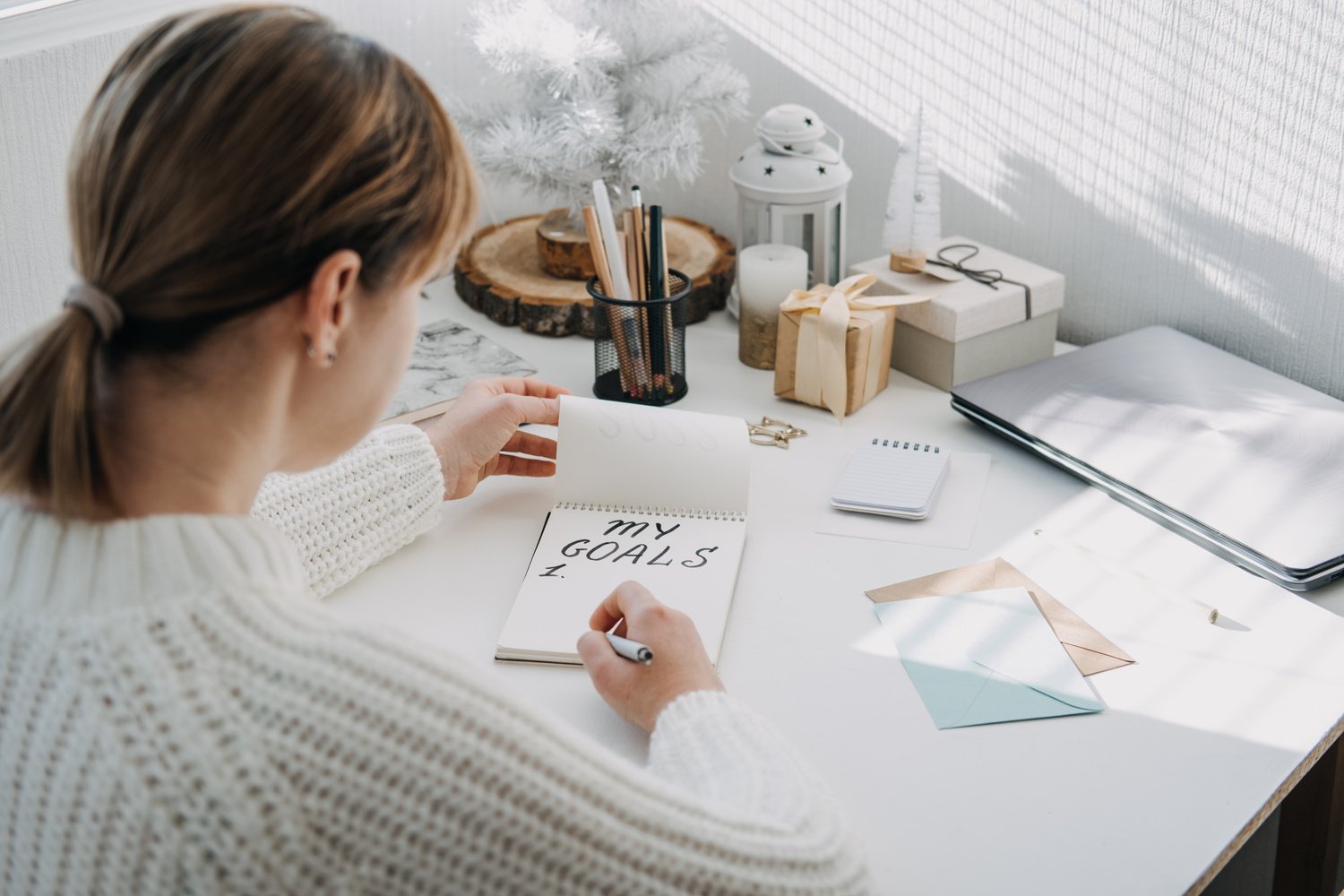 Woman in White Sweater Listing Her Goals